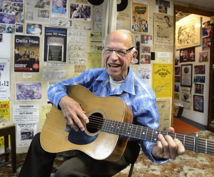 Maine bluegrass pioneer Al Hawkes plays guitar in his home studio in Westbrook in 2015. The man who 56 years ago built a 13-foot-tall TV repairman for the sign of his Route 302 shop turned 88 on Christmas Day, and died Friday.