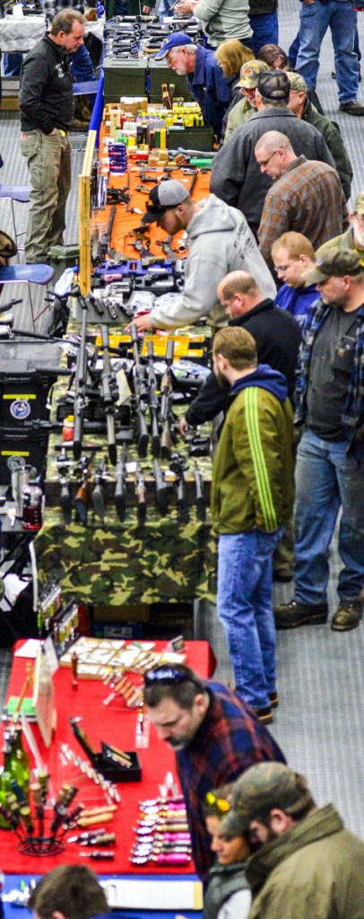 Attendees check out displays during a gun show Saturday at the Augusta Civic Center.