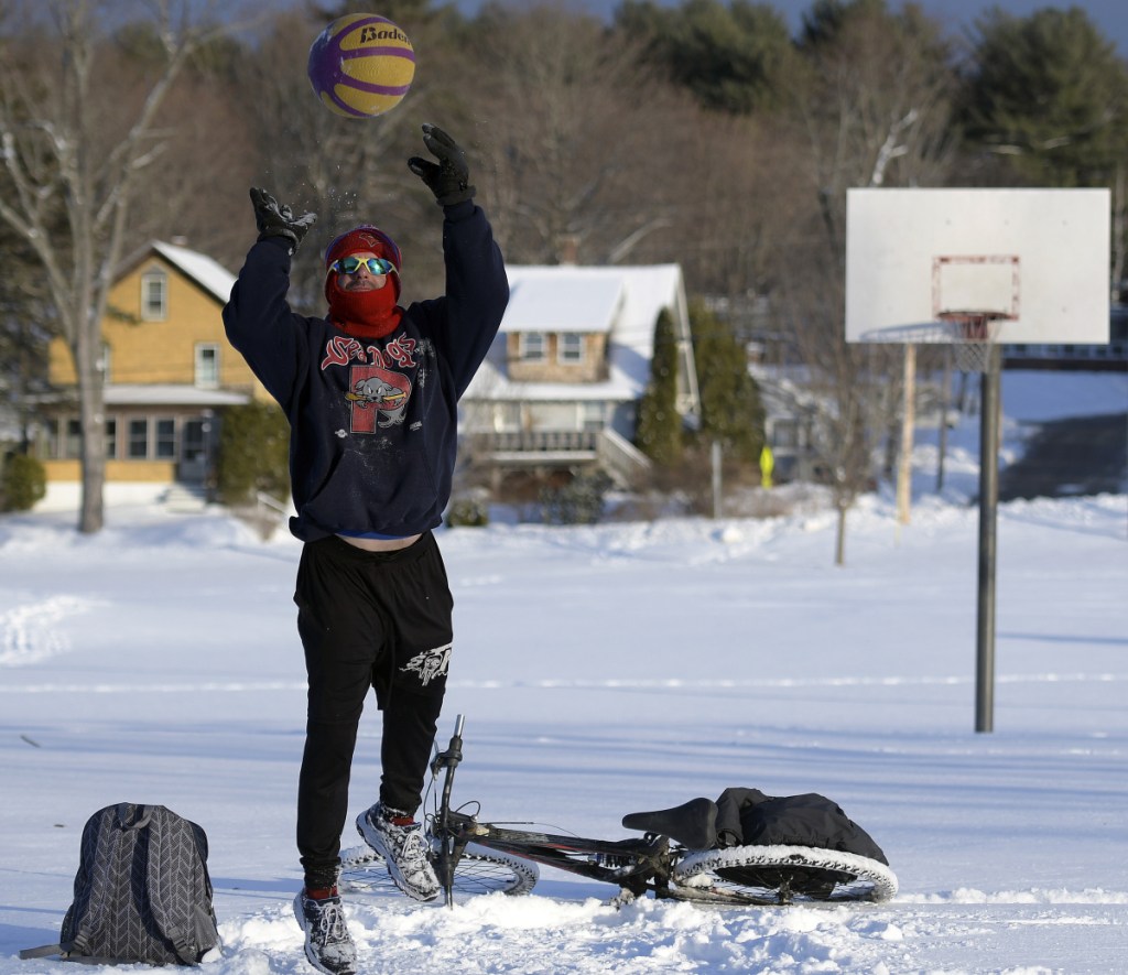 James Wiggins, of Augusta, shoots free throws Wednesday on a fresh coat of snow at Williams Playground in Augusta. Wiggins said he likes to play basketball in every kind of weather and rides his bicycle all year.