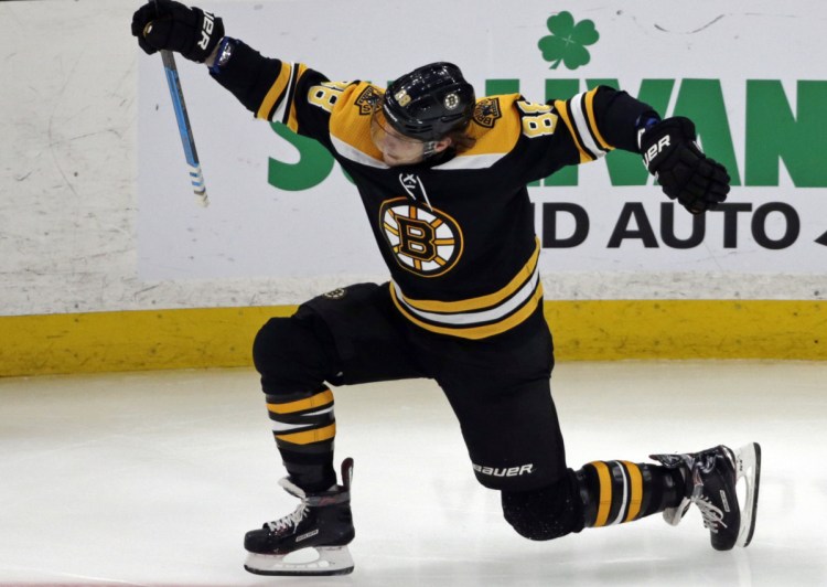 Boston Bruins right wing David Pastrnak (88) celebrates his goal in the third period of an NHL hockey game against the Calgary Flames, Thursday, Jan. 3, 2019, in Boston. (AP Photo/Elise Amendola)