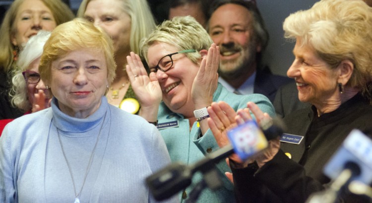 Gov. Janet Mills is applauded by Rep. Charlotte Warren, D-Hallowell, and Rep. Margaret Craven, D-Lewiston, at start of a State House news conference Tuesday, the 46th anniversary of the Roe v. Wade Supreme Court decision legalizing abortion.