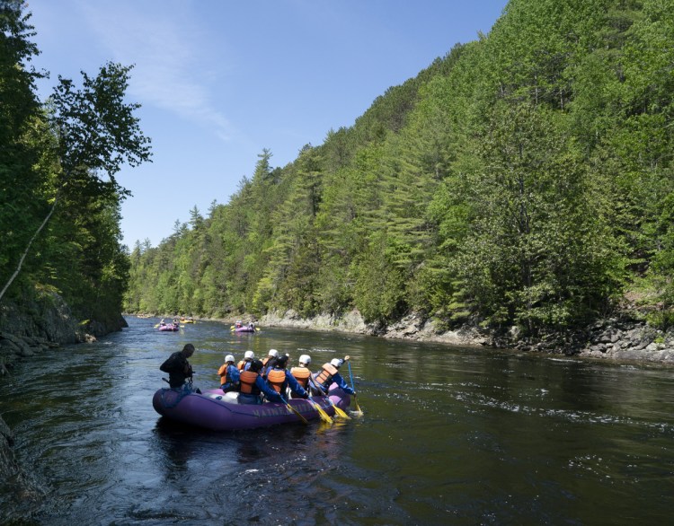 A raft heads down the Kennebec River near West Forks Plantation on June 13. The controversial CMP transmission line would run through western Maine.