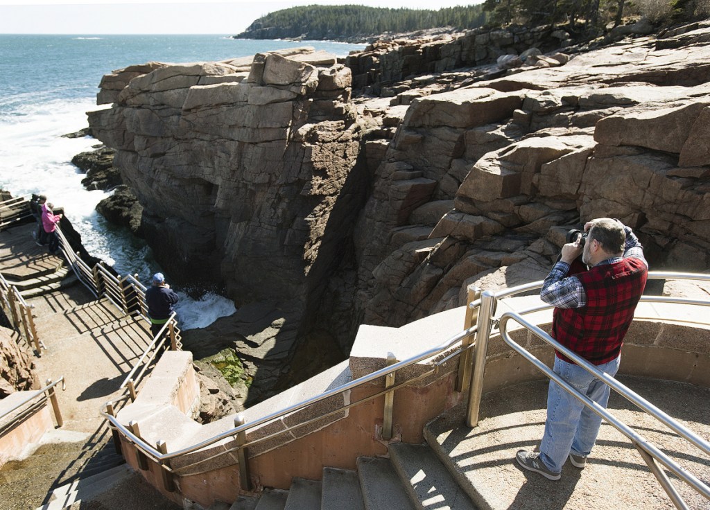People visit the Thunder Hole along Ocean Drive in Acadia National Park in April 2016. After the 35-day partial government shutdown, park officials say they don't know if everything will open on time come spring.