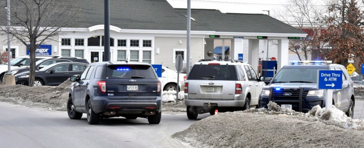 Three police vehicles block the entrance to the Bangor Savings Bank on Waterville Commons Drive on Feb. 12 after a robbery there. The robbery suspect, Jason Mackenrodt, 37, was sentenced Thursday to five years in prison for the crime.