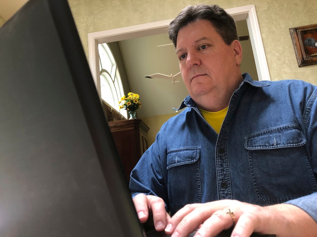 In this Friday, Feb. 15, 2019, photo Kevin McCreanor works on a laptop in Atlanta. The first tax filing season under the new federal tax law is proving to be surprising, confusing (and occasionally frightening) for some Americans. McCreanor and his wife normally get a sizeable refund each year. While they know waiting for a large refund isn’t the best strategy financially, they like a refund and they put anything they get back toward their daughters’ education. Their income, earned primarily from his wife’s job in telecom, can vary greatly, so there was comfort in never facing a big bill. 