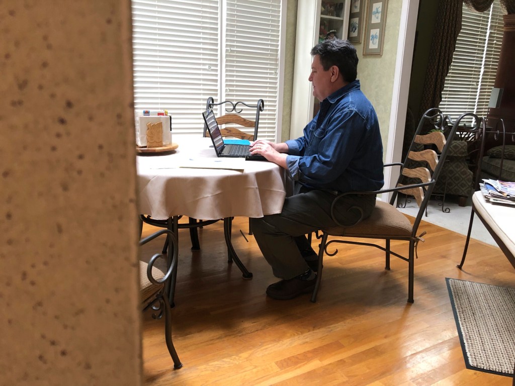 In this Friday, Feb. 15, 2019, photo Kevin McCreanor works on a laptop in Atlanta. The first tax filing season under the new federal tax law is proving to be surprising, confusing (and occasionally frightening) for some Americans. McCreanor and his wife normally get a sizeable refund each year. While they know waiting for a large refund isn’t the best strategy financially, they like a refund and they put anything they get back toward their daughters’ education. Their income, earned primarily from his wife’s job in telecom, can vary greatly, so there was comfort in never facing a big bill.