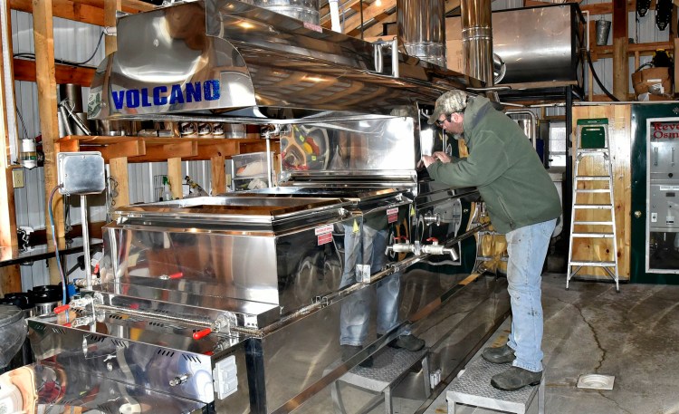 Maple syrup producer Jim Smith peers into his evaporator Tuesday in preparation for another boil at his Smith Brothers Maple Syrup Products operation in Skowhegan. Smith said the sap was running and he made 60 gallons of syrup last Sunday. He is taking part in the annual Skowhegan Maple Fest, which begins this Friday and runs through Sunday, which is Maine Maple Sunday. 