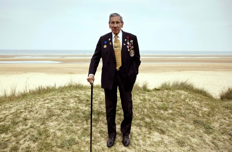 World War II and D-Day veteran Charles Norman Shay, from Indiann Island, Maine, stands at the Charles Shay monument on Omaha Beach in Normandy, France, in 2019. 