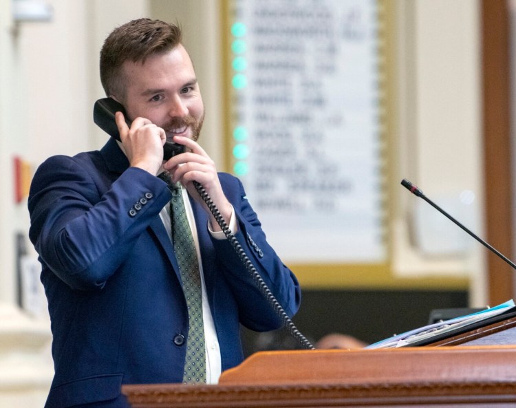 AUGUSTA, ME - JUNE 30: Speaker of the House Ryan Fecteau, D-Biddeford, chats on the phone with Republican House leader Rep. Kathleen Dillingham, R - Oxford, during quorum vote at start of session Wednesday June 30, 2021 at The Maine State House in Augusta. During sessions The Speaker sometimes talks to the leaders of the two major parties on the phone as they sit at their desks in opposite corners of the large chamber. It was the first day of the 130th Legislature that members could attend with out a face covering. (Staff photo by Joe Phelan/Staff Photographer)