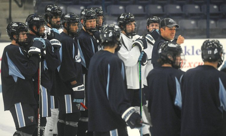 University of Maine men's hockey coach Ben Barr, right, directs the team during practice at Alfond Arena in Orono last week.