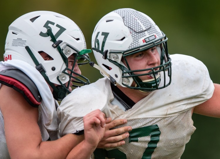 Leavitt senior Jack Boutaugh (67) fights to get past the block of teammate Reeve Twitchell (57) during a drill at Tuesday's practice in Turner. Boutaugh and Twitchell are two of the top linemen in the state and an integral part of the Hornets' success so far this season.