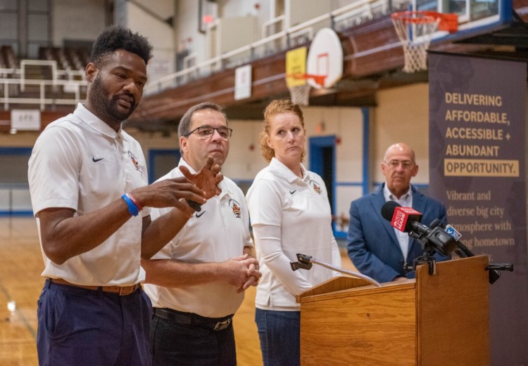 Josh Brister, left, Jim Savey, director of Basketball operations, Jen Buchanan, and Lewiston Mayor Mark Cayer appear at a press conference Thursday at the Lewiston Armory to announce the area's new women's basketball team, the Maples. Brister and Buchanan are co-owners of the team.