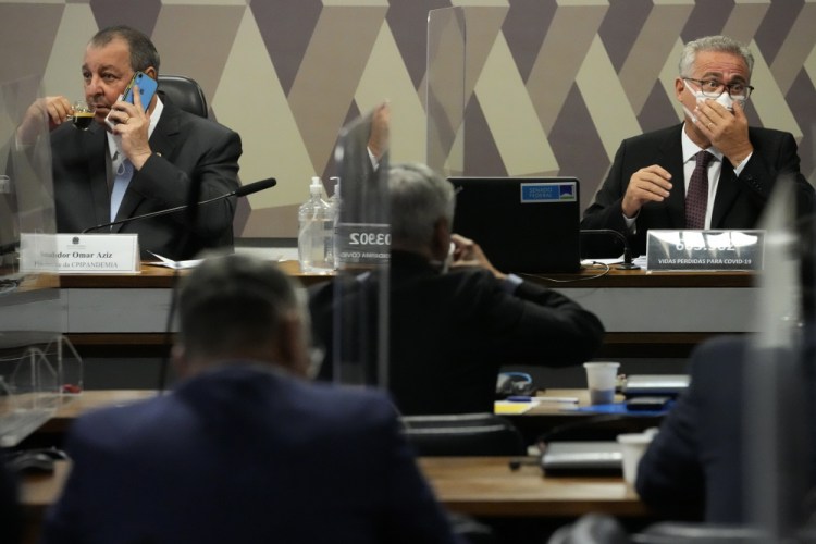 Senators Omar Aziz, left, and Renan Calheiros attend a session by their commission investigating the government's management of the COVID-19 pandemic at the Federal Senate in Brasilia, Brazil, on Wednesday. 