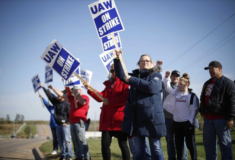 Members of the United Auto Workers strike outside of the John Deere Engine Works plant on Ridgeway Avenue in Waterloo, Iowa, on Friday. 