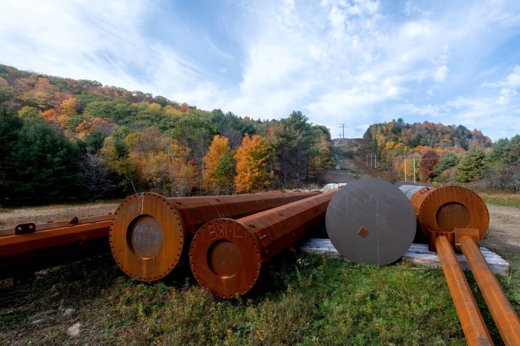 Steel power poles are stacked along the path of the NECEC corridor on Oct. 13 in Concord.