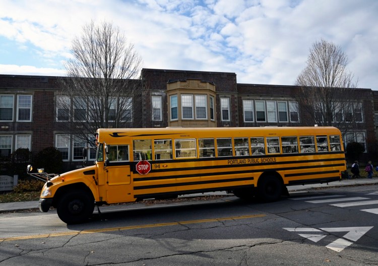 A bus leaves Portland's Longfellow School on Monday after picking up students to bring them home. The school district is struggling to keep buses running, with an ongoing shortage of drivers.