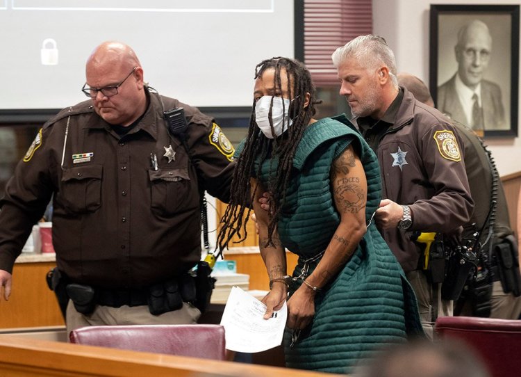 Darrell Brooks is taken out of the courtroom after making his initial appearance Tuesday in Waukesha County Court in Waukesha, Wis. Prosecutors have charged Brooks with intentional homicide in the deaths of at least five people who were killed when an SUV was driven into a Christmas parade.