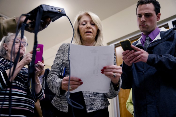 Mesa County, Colorado, Clerk Tina Peters, center, shown in March, was prohibited from supervising November elections by a judge who cited her efforts to sneak in an outsider to copy the hard drives of Mesa County voting machines. 