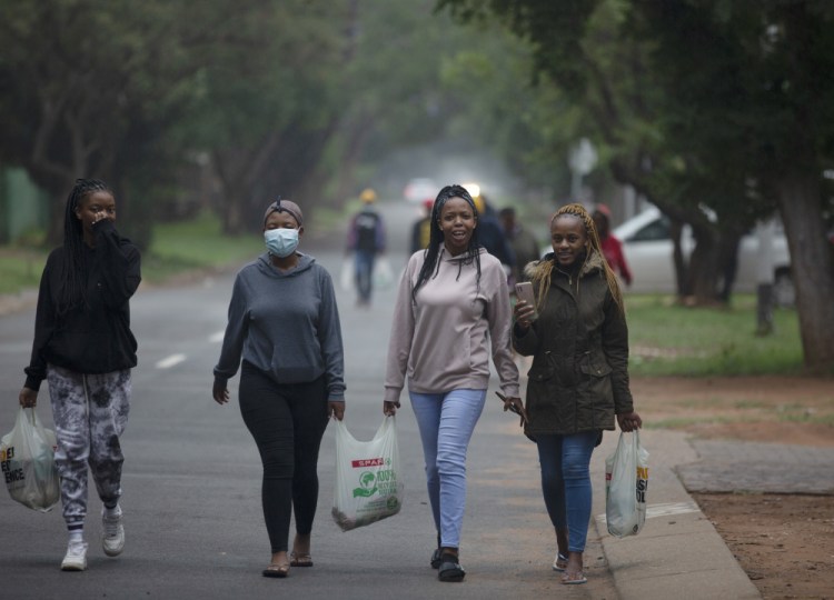 Students from the Tshwane University of Technology make their way back to their residence in Pretoria, South Africa, on Saturday. As the world grapples with the emergence of the new variant of COVID-19, scientists in South Africa – where omicron was first identified – are scrambling to combat its spread across the country. 
