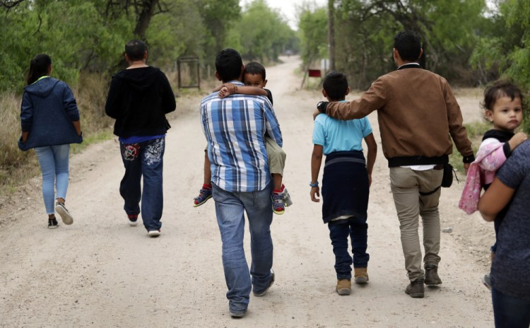 A group of migrant families walk from the Rio Grande, the river separating the U.S. and Mexico in Texas, near McAllen, Texas. 