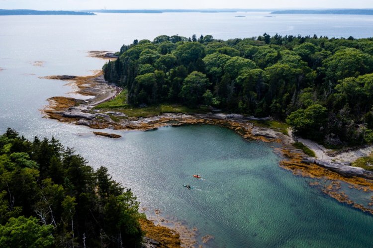 An aerial view of kayakers paddling around Little Whaleboat Island in Casco Bay.
