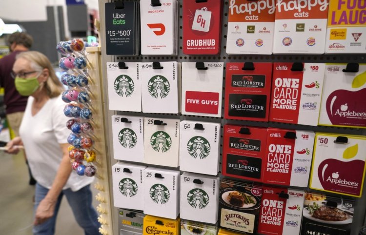 Gift cards for food and beverage businesses sit on display for sale at a retail store in Dallas on Nov. 16. Many shoppers will turn more to gift cards if they don't like the choice of products on the shelves.