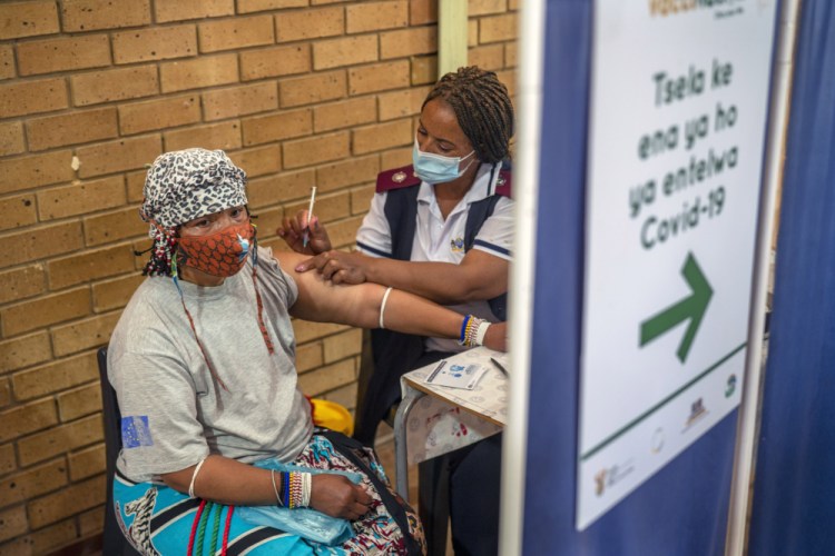 An Orange Farm, South Africa, a resident receives her vaccination against COVID-19 on Friday. South Africa has accelerated its vaccination campaign a week after the discovery of the omicron variant of the coronavirus. 