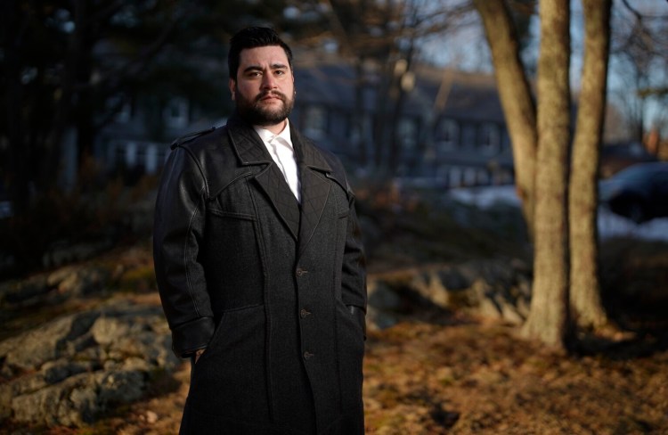 Bryce Clark stands in an area outside his Portland condominium that was a favorite spot of his father, Perry Clark. His father died of COVID-19. Bryce Clark had tried to persuade him to get vaccinated.