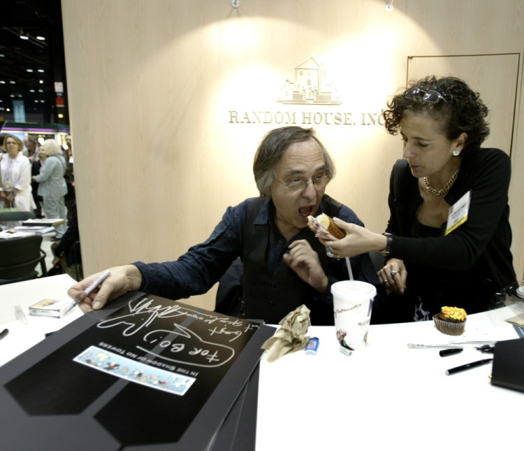 Artist and author Art Spiegelman gets some help with his lunch from Francoise Mouly, of Random House, Inc., during a signing of Spiegelman's new book "In the Shadow of No Towers" at the Book Expo America convention, Saturday, June 5, 2004, in Chicago.  A Tennessee school district has voted to ban a Pulitzer Prize winning graphic novel about the Holocaust due to “inappropriate language” and an illustration of a nude woman. 