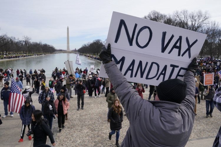 Protesters gather for a rally against COVID-19 vaccine mandates in front of the Lincoln Memorial in Washington on Sunday. On Tuesday, the Biden administration said it has officially withdrawn a rule that would have required workers at big companies to get vaccinated or face regular COVID testing. 