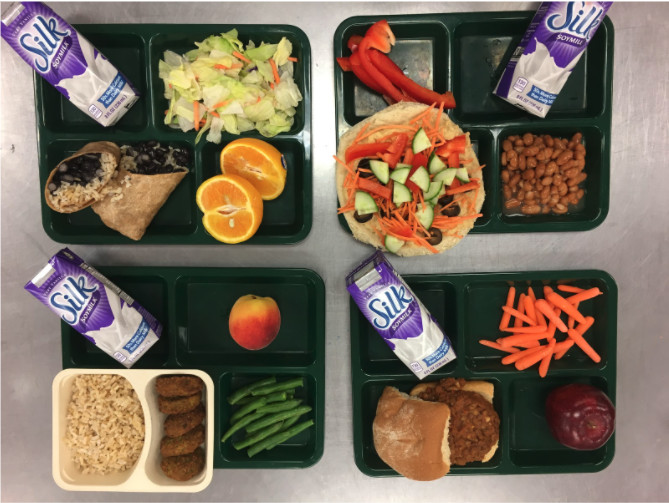 Vegan hot lunches being served in Portland’s elementary school include, clockwise from left, rice and bean burritos, build-your-own hummus pizza, veggie burgers and falafel and rice. 