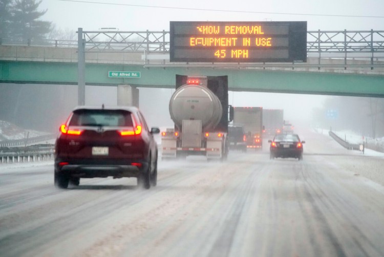 Cars and trucks travel northbound along the Maine Turnpike in Arundel through a messy wintry mix  on Friday morning. The speed limit on the turnpike is reduced to 45 mph. 