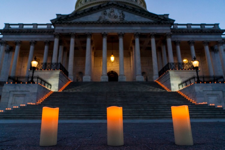 Electric candles await a bipartisan group of members Congress for a moment of silence honoring the 500,000 U.S. COVID-19 deaths on Feb. 23, 2021, by the east front steps of the Capitol in Washington. The death toll now stands at more than 900,000.
