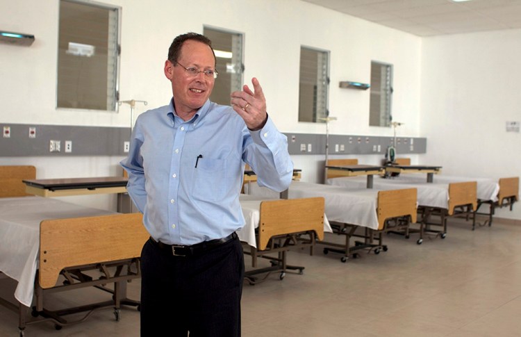 Partners in Health's co-founder Dr. Paul Farmer gestures during the inauguration of a national referral and teaching hospital in Haiti on Jan. 10, 2012. Farmer, a physician, humanitarian and author renowned for providing health care to millions of impoverished people, has died at 62.