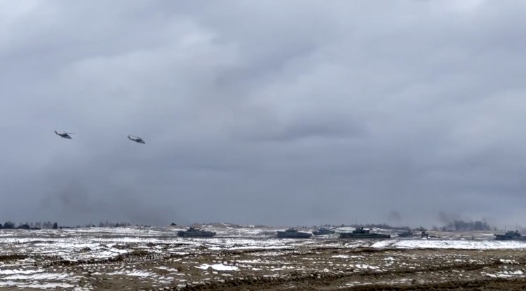 In this photo taken from video and released by the Russian Defense Ministry Press Service on Wednesday, Russian and Belarusian tanks and military helicopters attend  joint military drills at Brestsky firing range, Belarus. The combat training was held as tensions remain high under the looming threat of war with Ukraine.