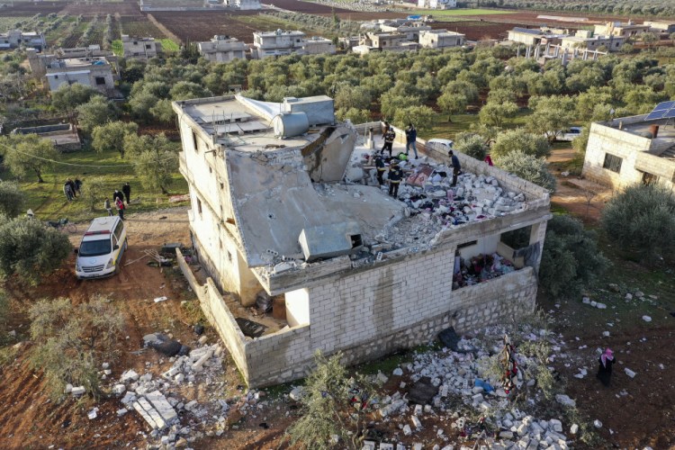 People inspect a destroyed house following an operation by the U.S. military in the Syrian village of Atmeh, in Idlib province, Syria, on Thursday.