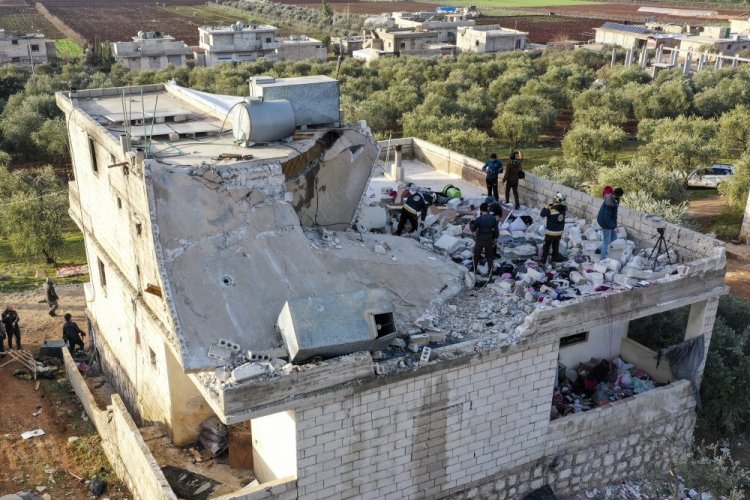 People inspect a destroyed house following an operation by the U.S. military in the Syrian village of Atmeh, in Idlib province, Syria, on Thursday. 