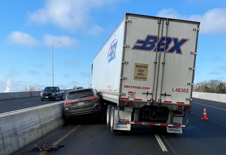 A tractor trailer pinned an SUV against the concrete barrier in the median of I-95 on Wednesday morning. No one was seriously injured.