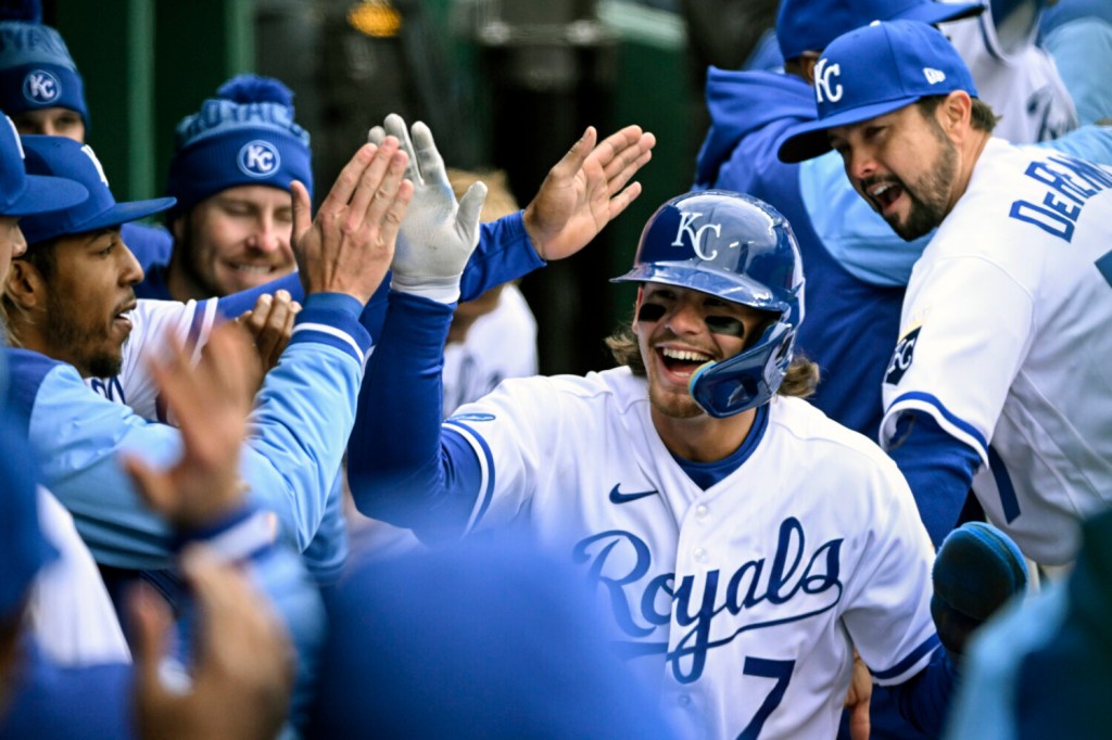 Kansas City Royals' Bobby Witt Jr. (7) is congratulated after scoring a run against the Cleveland Guardians during the eighth inning of a baseball game, Thursday, April 7, 2022 in Kansas City, Mo. (AP Photo/Reed Hoffmann)