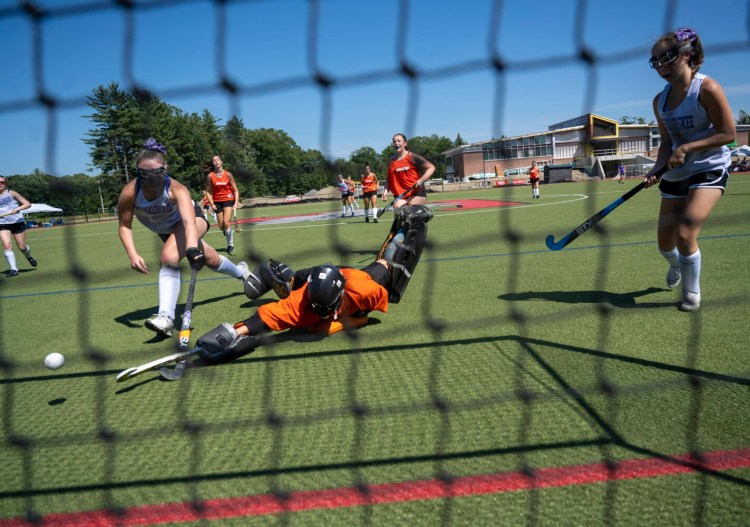 WATERVILLE, MAINE - JULY 23, 2022Winslow High School goalie Laine Bell (22) makes a save against Messalonskee at the Victories Over Violence field hockey tournament at Thomas College in Waterville on Saturday, July 23, 2022. (Photo by Michael G. Seamans/Staff Photographer)