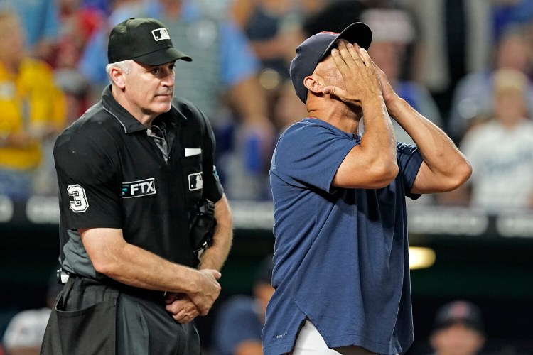 Boston Red Sox manager Alex Cora argues a call with home plate umpire Bill Welke during the seventh inning of a baseball game against the Kansas City Royals Thursday, Aug. 4, 2022, in Kansas City, Mo. (AP Photo/Charlie Riedel)