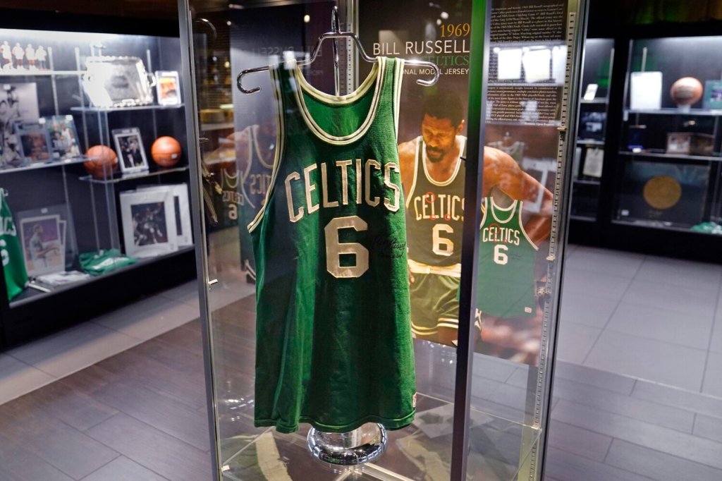 FILE - The 1969 game worn jersey of Boston Celtics' legend Bill Russell is displayed along with other memorabilia set to go up for auction, Thursday, Dec. 9, 2021, in Boston. Bill Russell’s No. 6 jersey is being retired across the NBA. The league and the National Basketball Players Association made the announcement Thursday, Aug. 11, 2022, permanently retiring the number worn by the 11-time champion, civil rights activist and someone good enough to have been enshrined in the Basketball Hall of Fame as both a player and a coach. He died on July 31 at the age of 88. (AP Photo/Charles Krupa, File)