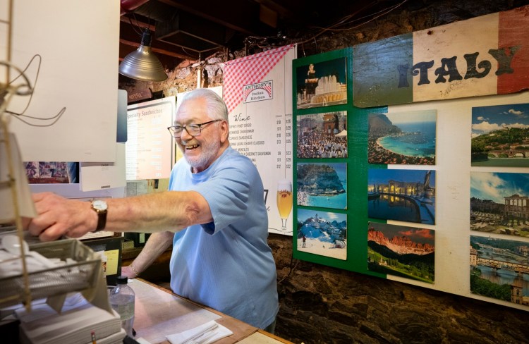 Proprietor Anthony Barrasso reaches for plasticware while taking orders at Anthony's Italian Kitchen. He opened the restaurant in the same spot some 30 years ago and still serves food based on his mother's recipes. 