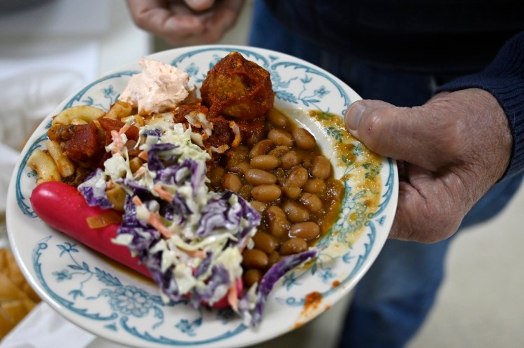 A plate with classic Maine baked beans (and a classic red snapper) at a recent Peoples United Methodist Church baked bean supper in South Portland earlier this month. The church has recently resumed the monthly suppers, which had stopped for two years because of the pandemic. 