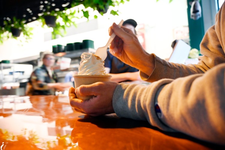 Alec Rutter of Biddeford eats coconut soft-serve ice cream at Fish & Whistle in late May. House-made soft serve is trending in restaurants in Maine.
