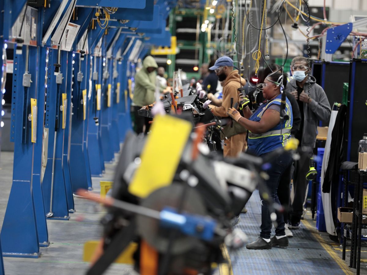 Employees work on the assembly line at the Dakkota Integrated Systems manufacturing facility in Detroit, Michigan, U.S., on Thursday, May 5, 2022.